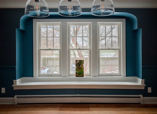 Teal dining room with pendant lights